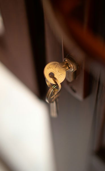 a-close-up-of-a-key-on-a-door.jpg a close up of a key on a door